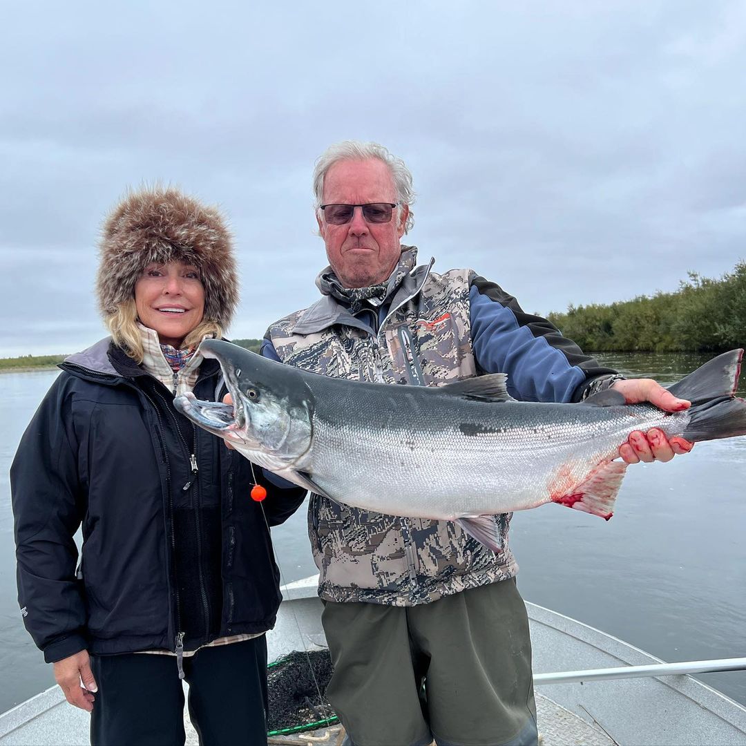Anglers reeling in a big fish in Alaska