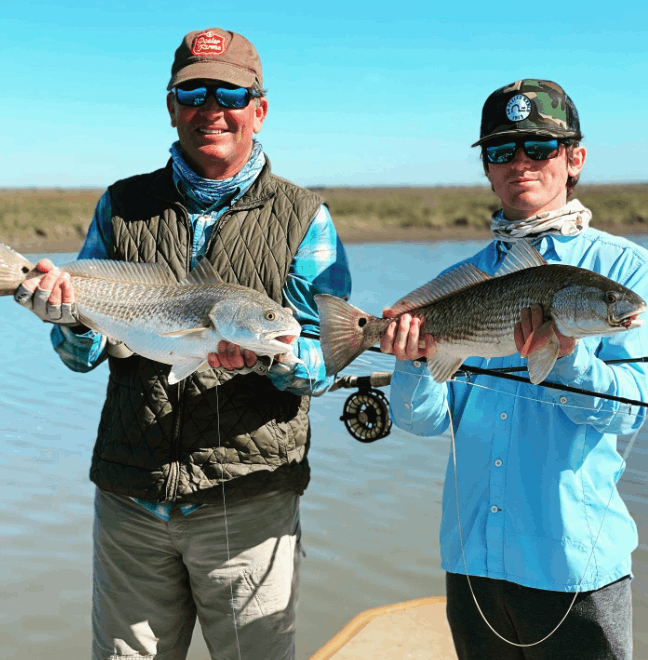 Two people holding a 12-inch fish in TX