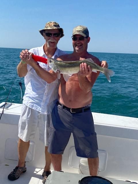 Two people fishing at the lakeside in Marblehead