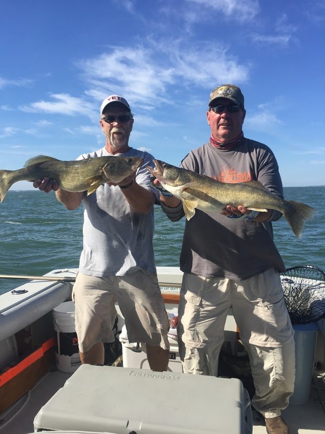 Two people fishing in Ohio with 2 large fish