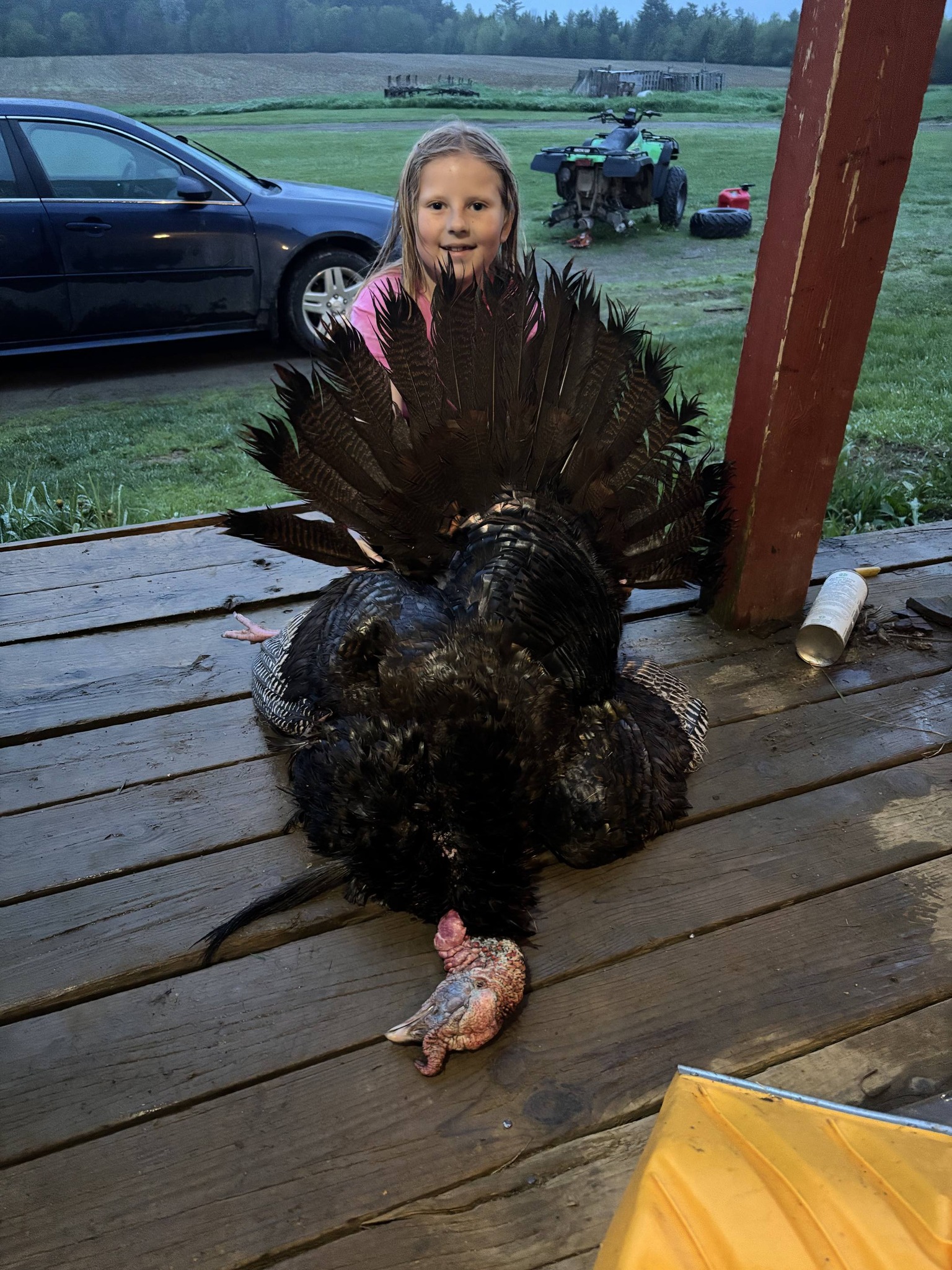Wild turkey hunting success in Palmyra Maine with harvested bird displayed on wooden deck
