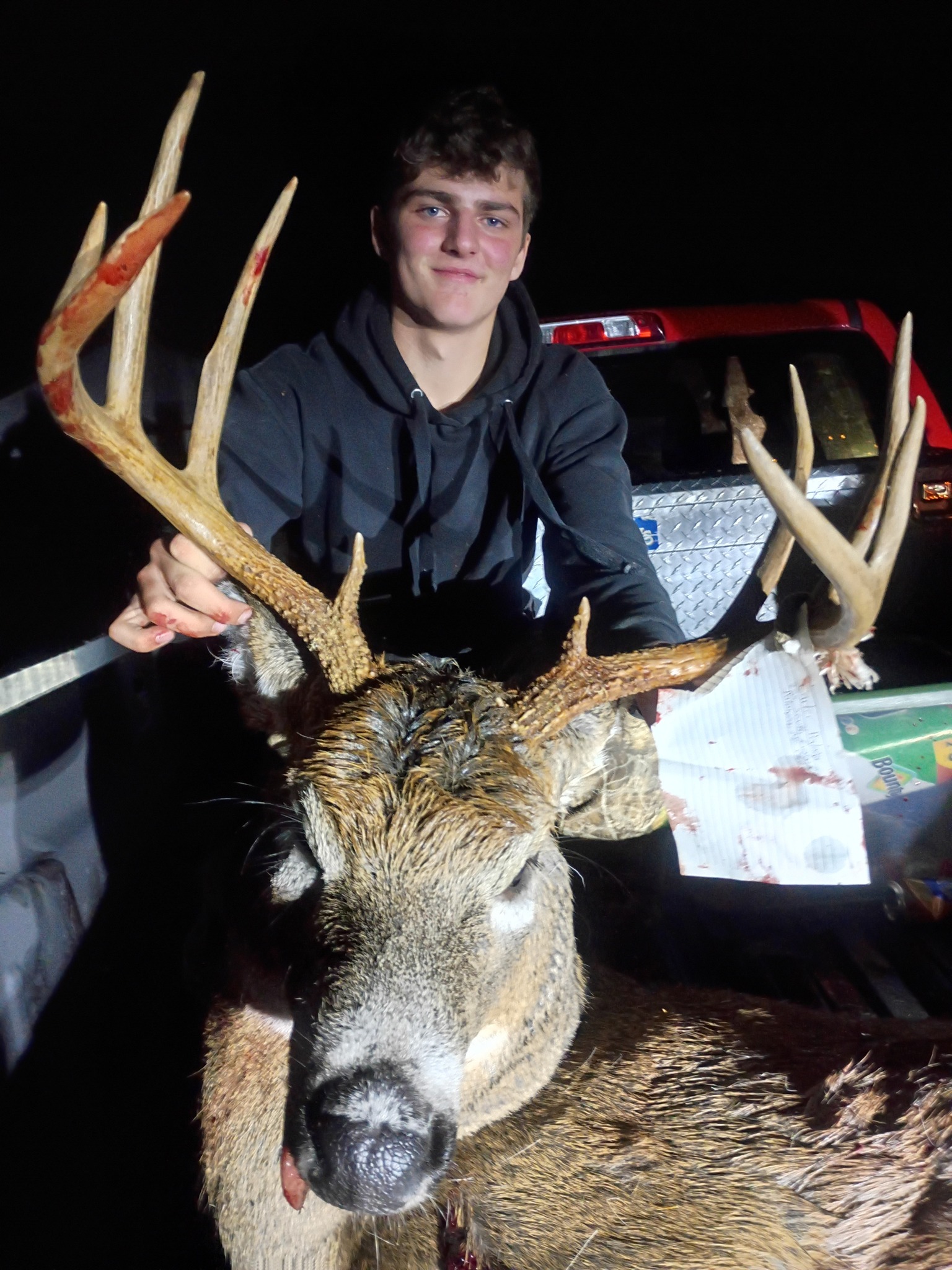 Successful deer hunt in Palmyra ME showing harvested whitetail buck with large antler rack