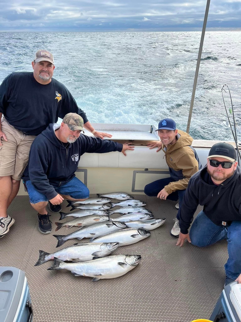 4 people fishing in Wisconsin with 3 big fish