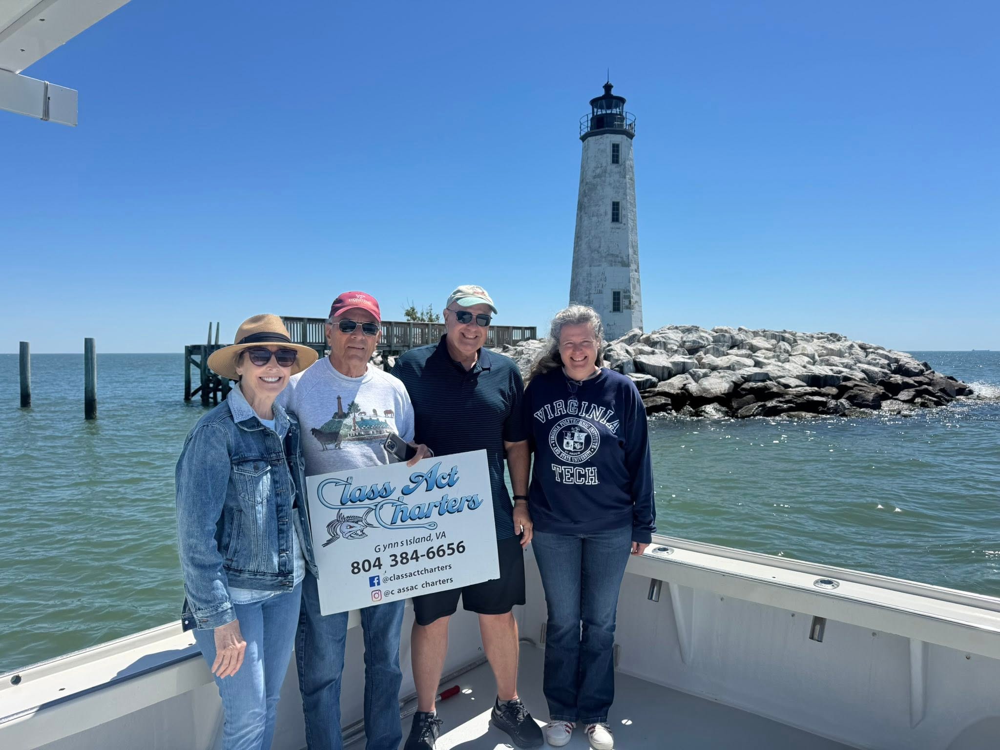 Fishing charter group on boat near lighthouse at Gwynn Island VA