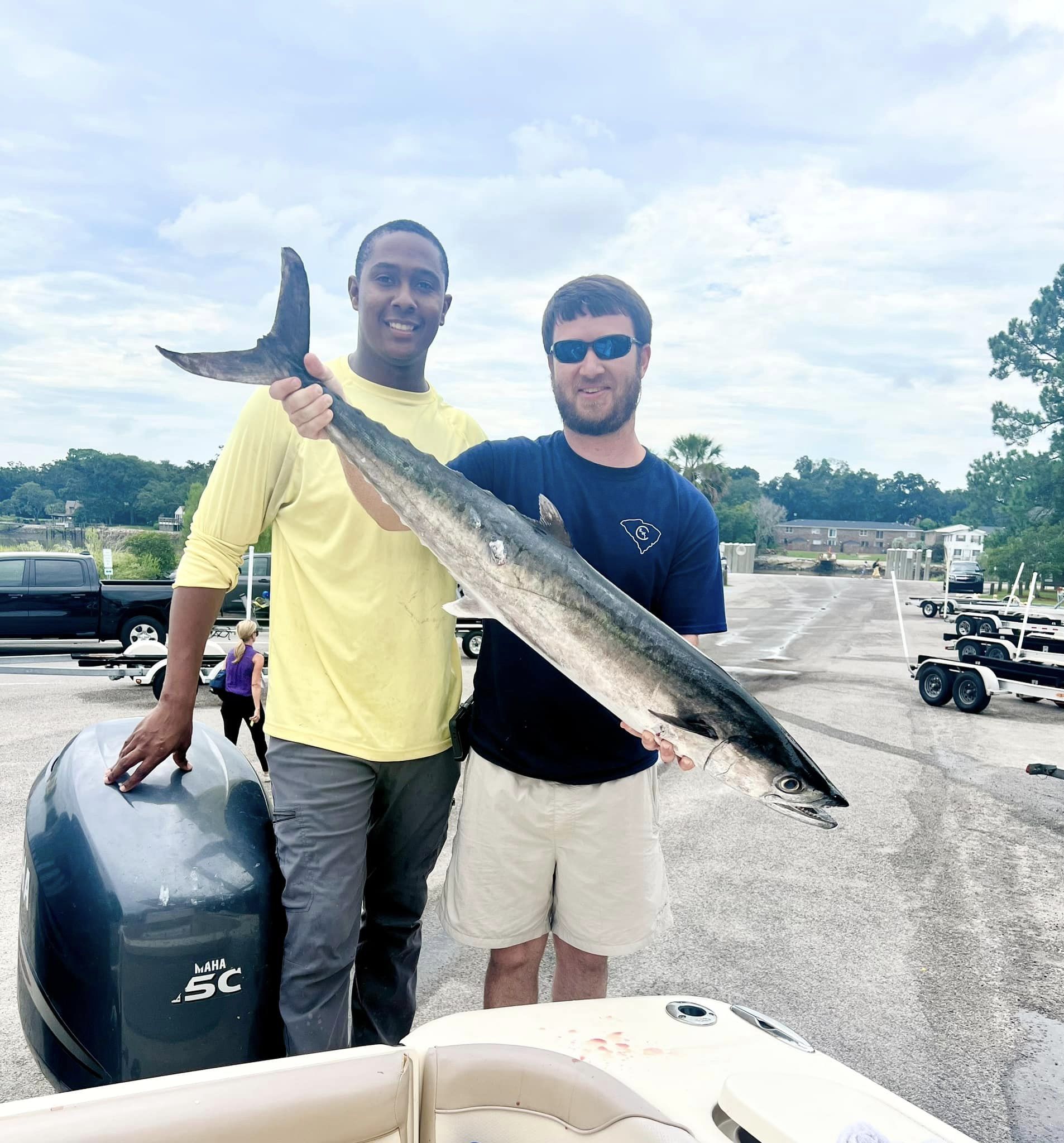 Two people fishing on the coast of Charleston