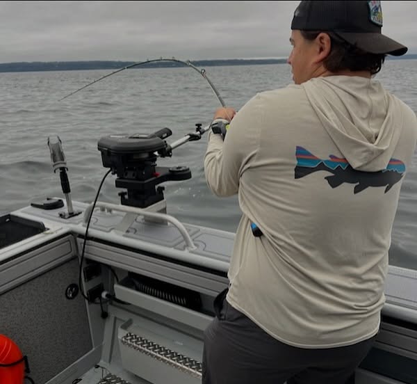 Fishing rod bent with fish on the line from boat in Edmonds WA waters