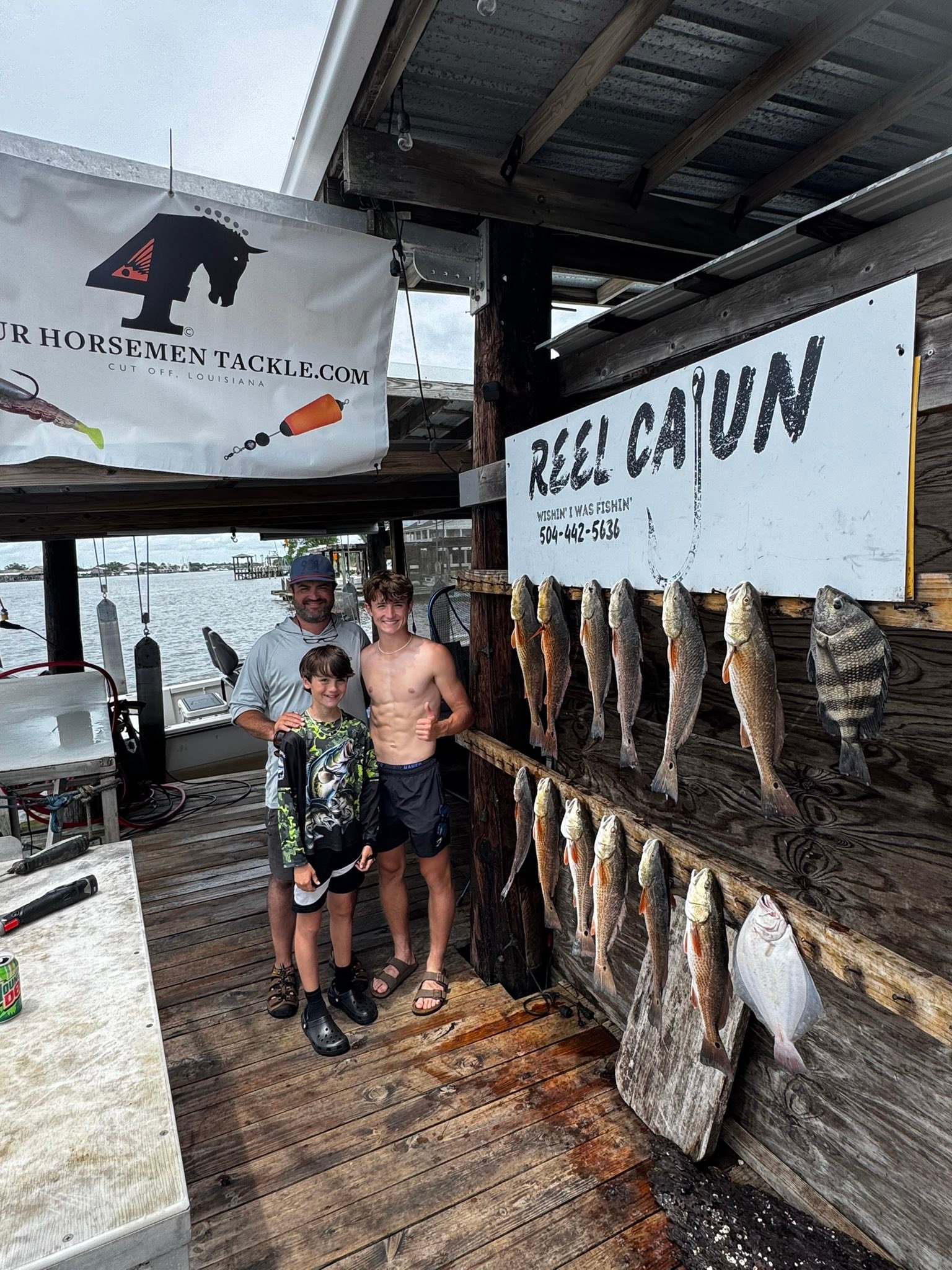 Successful fishing trip in Lafitte LA with catch of redfish and sheepshead displayed on wooden dock