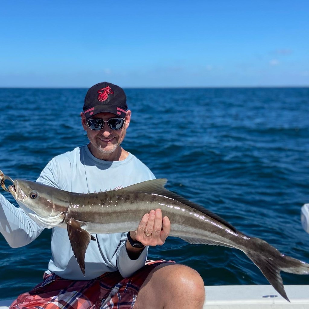 A lone angler reeling in a catch in the sunny waters of FL