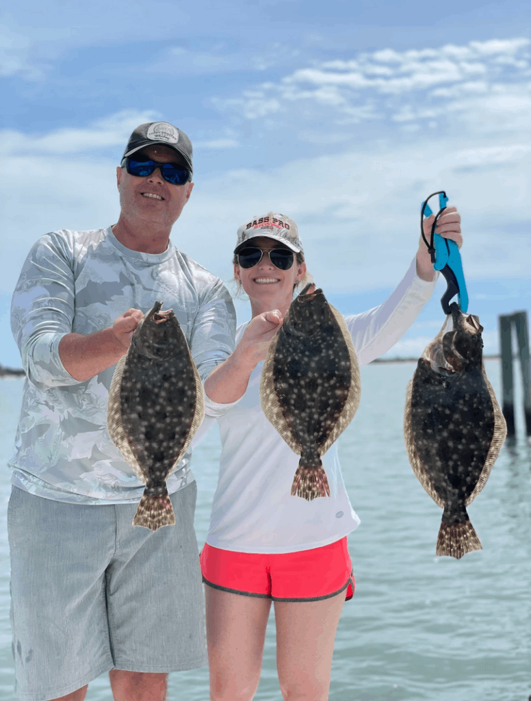 Three summer flounder, a southern flounder, and two people fishing in St. Augustine