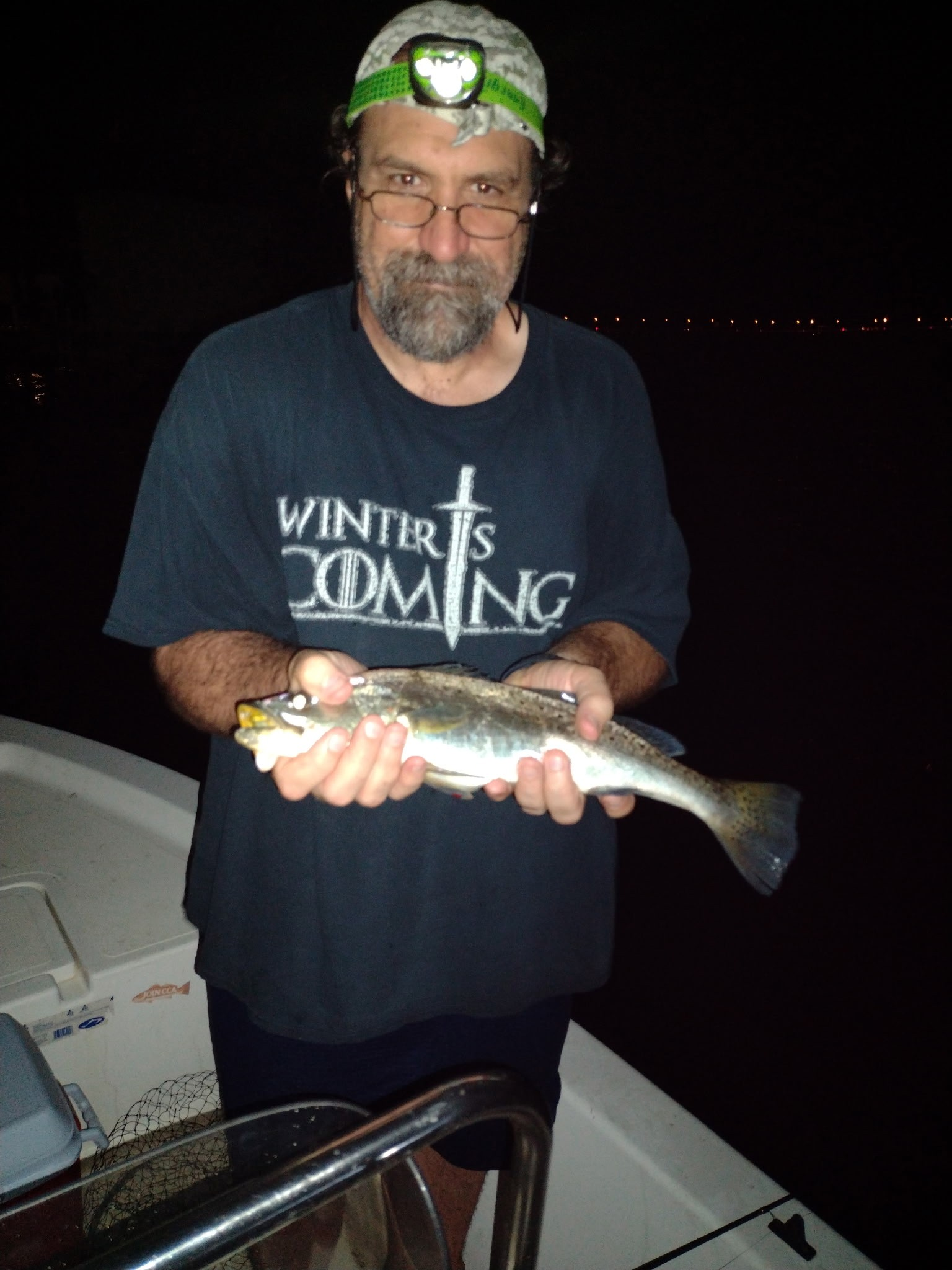 Angler holding a 14-inch fish while fishing in FL