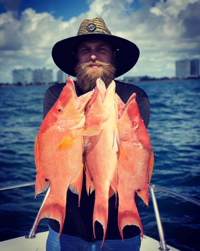 Fisherman with 3 big fish on the shore in FL