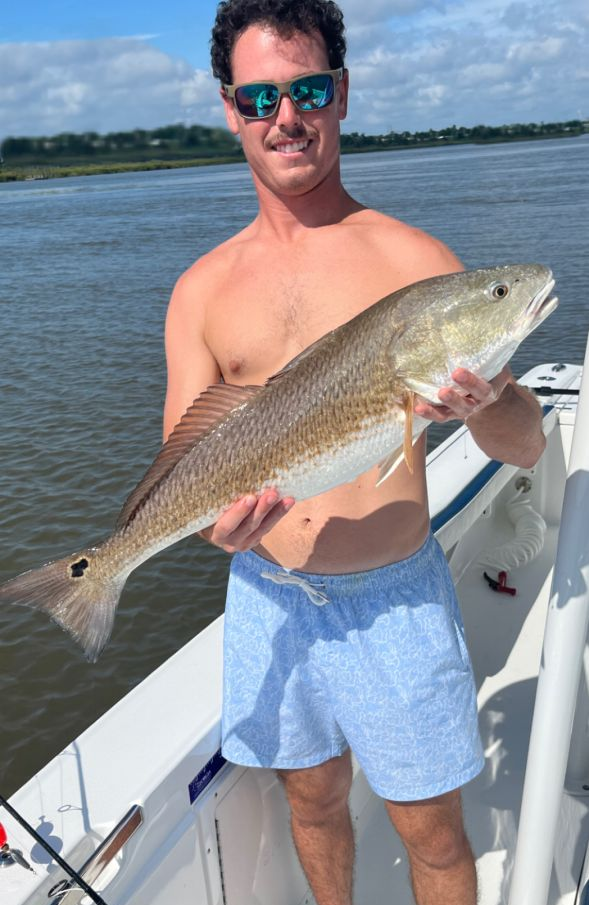 Angler holding a large redfish caught in Savannah