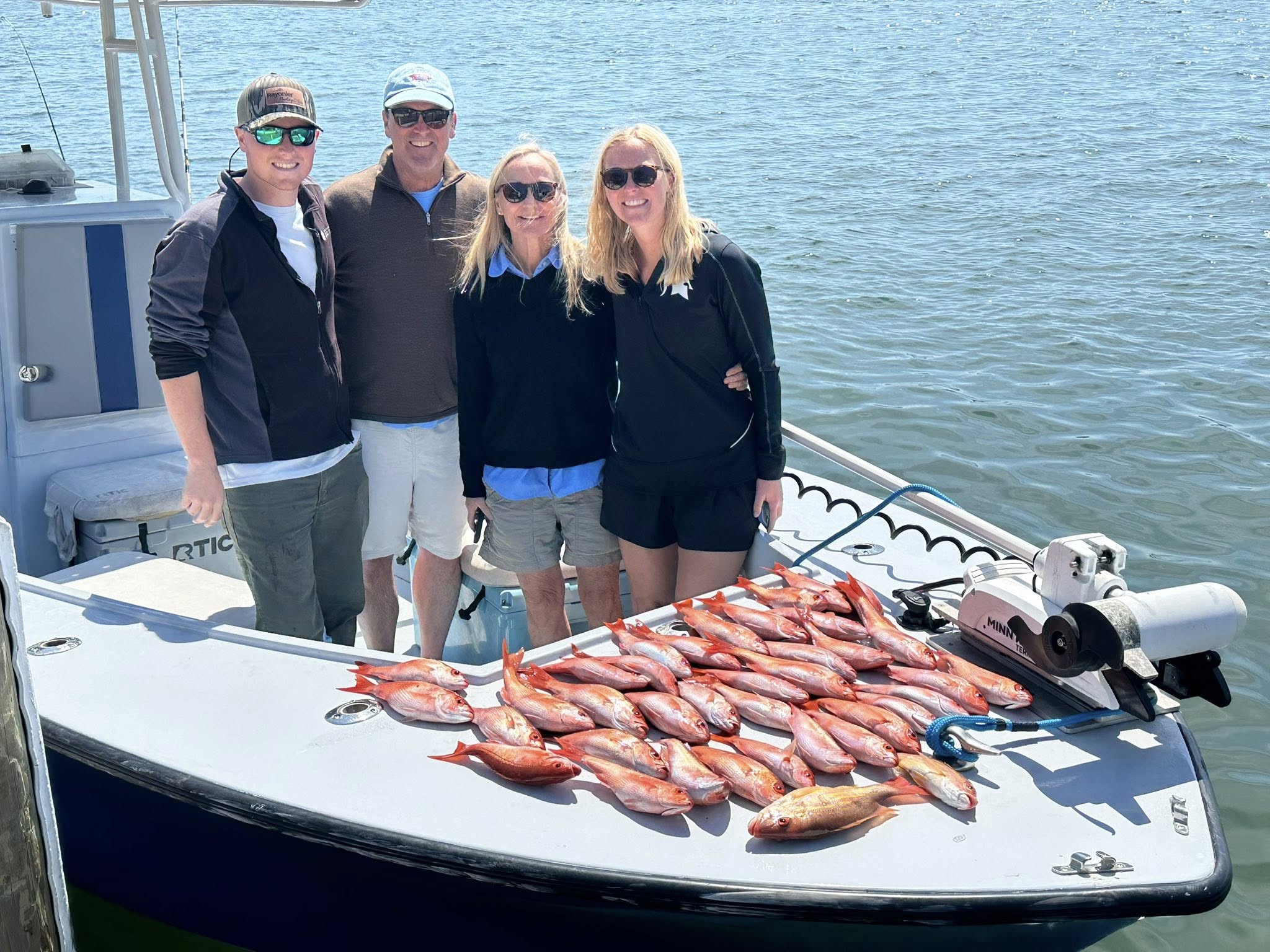 Successful lane snapper fishing trip in Pensacola FL with large catch displayed on boat deck