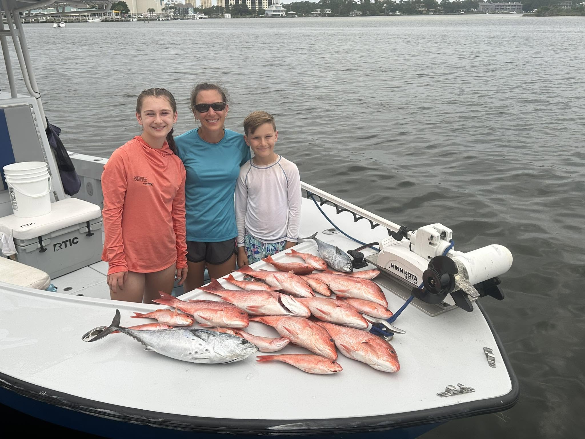 Successful fishing trip in Pensacola FL showing catch of Little Tunny and Red Snapper on boat deck