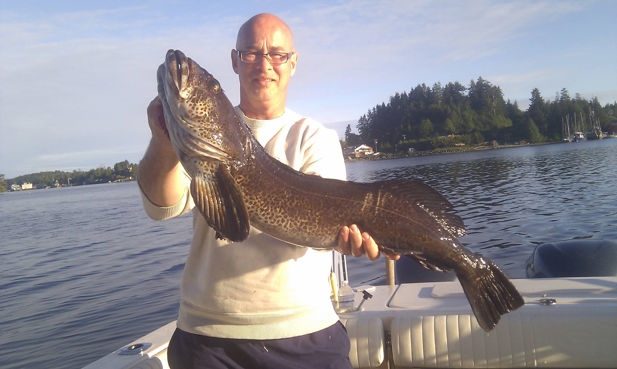 A person fishing in Ucluelet, catching a 29-inch fish