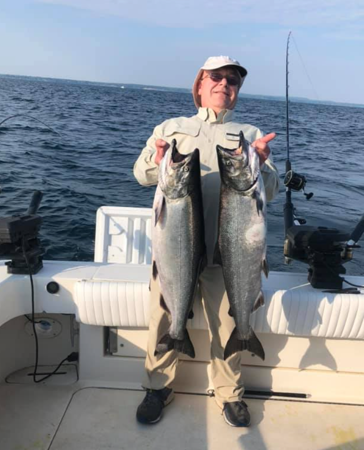 Two chinook salmon and coho salmon, a fishing scene in NY