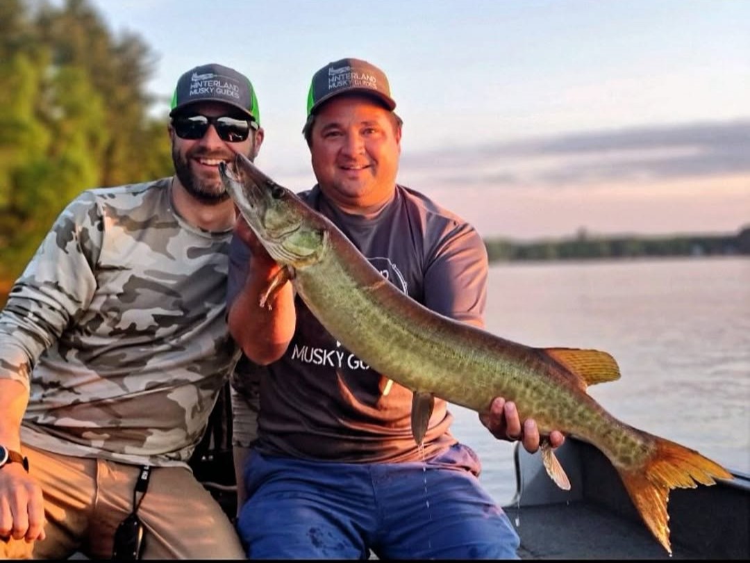 Two anglers musky fishing on Wisconsin lake with professional guide and tackle included