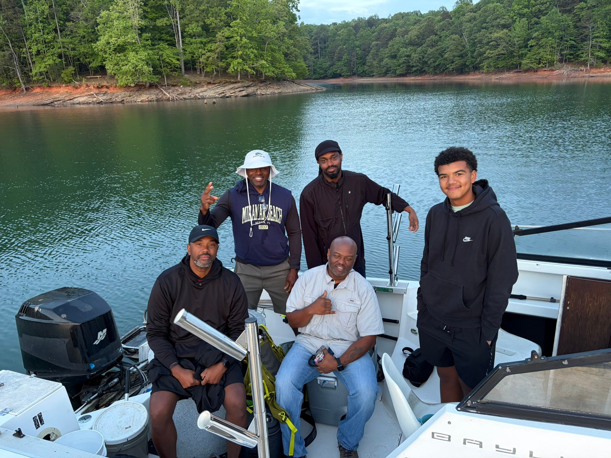 Fishing boat on calm lake in Cumming GA surrounded by forested shoreline