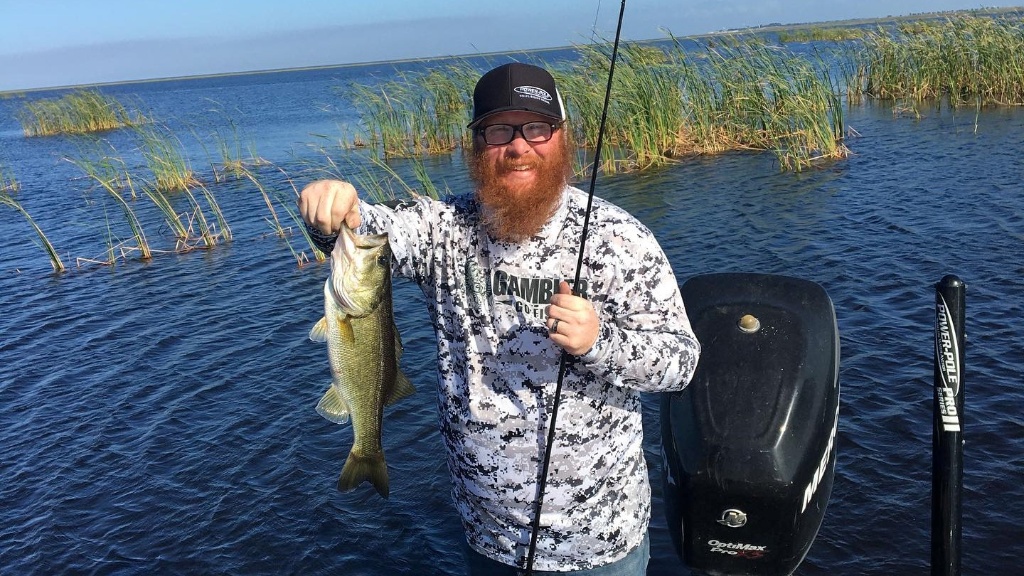 Angler holding a 14-inch fish in Okeechobee