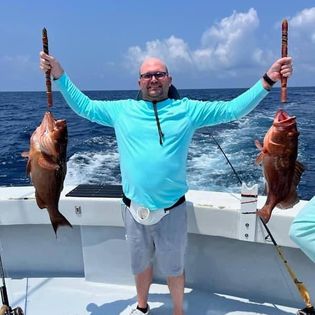 Two fishing rods with a person and location in FL