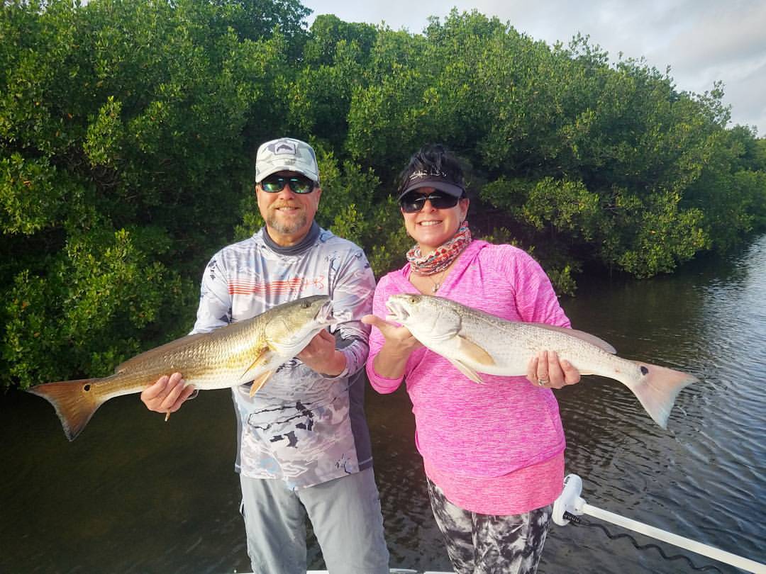 Two anglers holding large fish in Florida