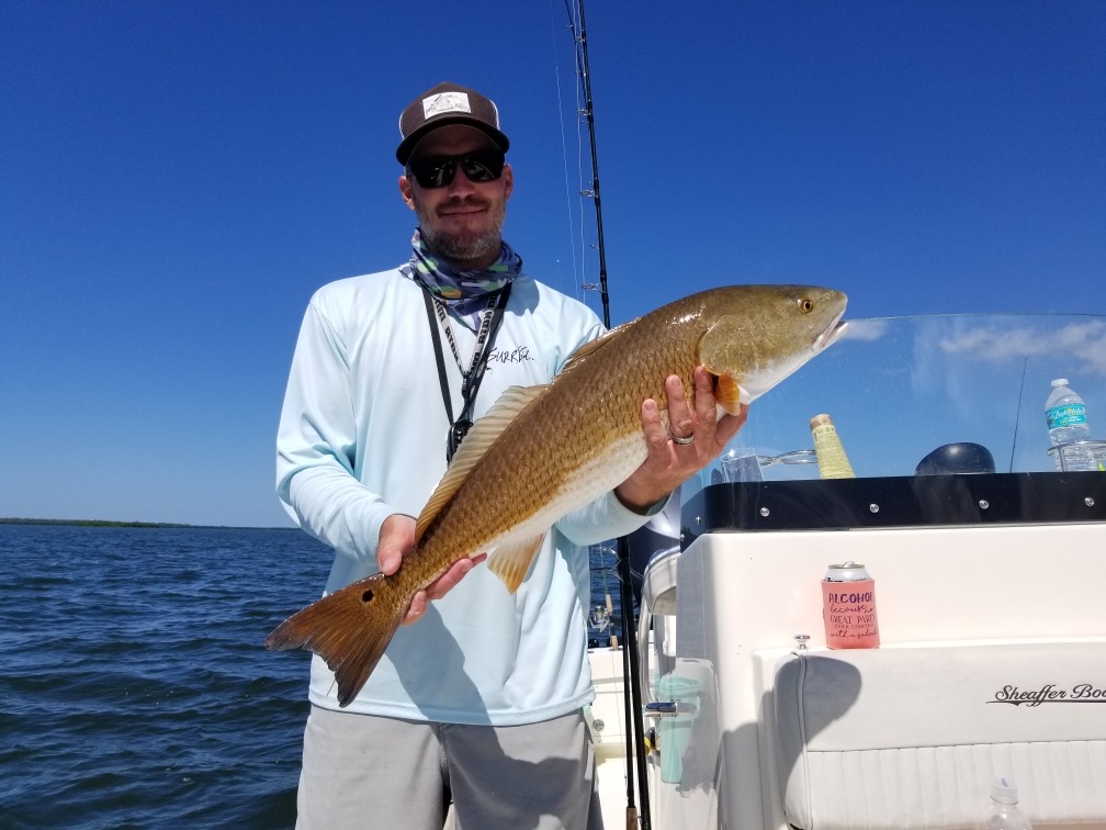 Angler with a large redfish caught in FL