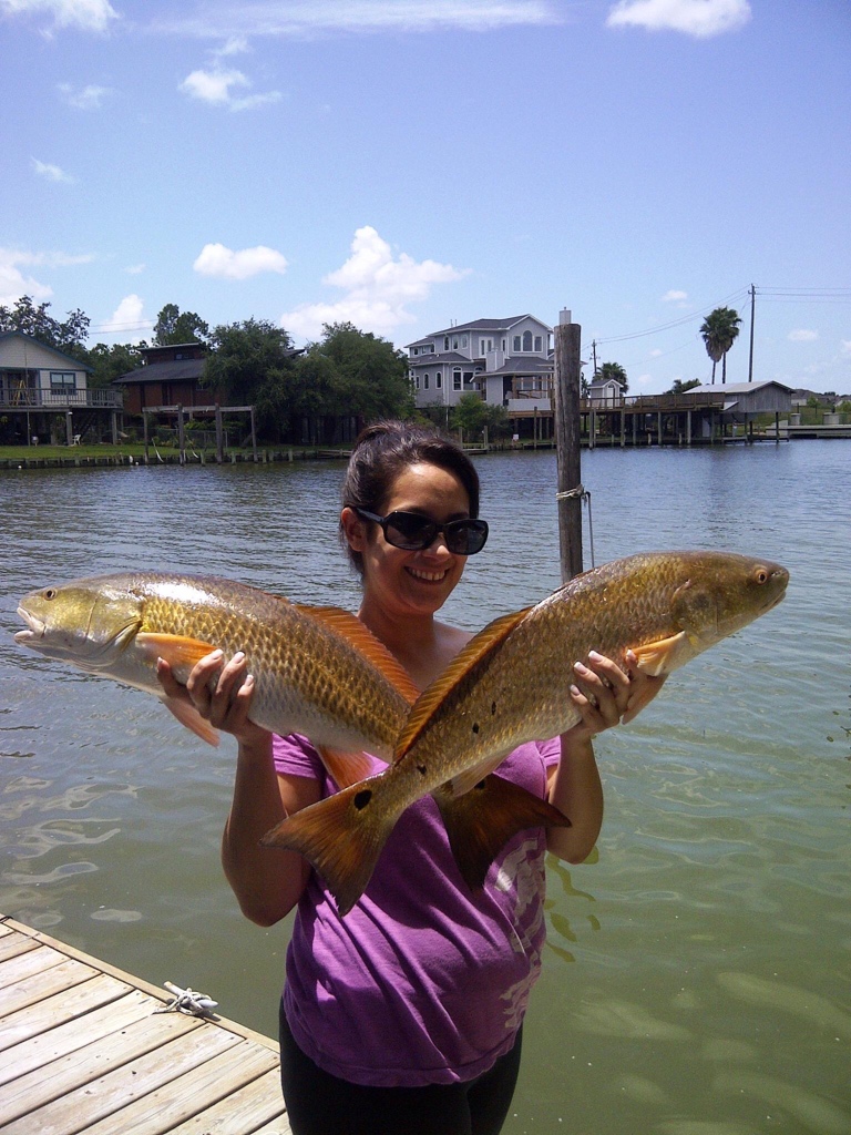 Two redfish, each around 22 inches long, caught in Kemah