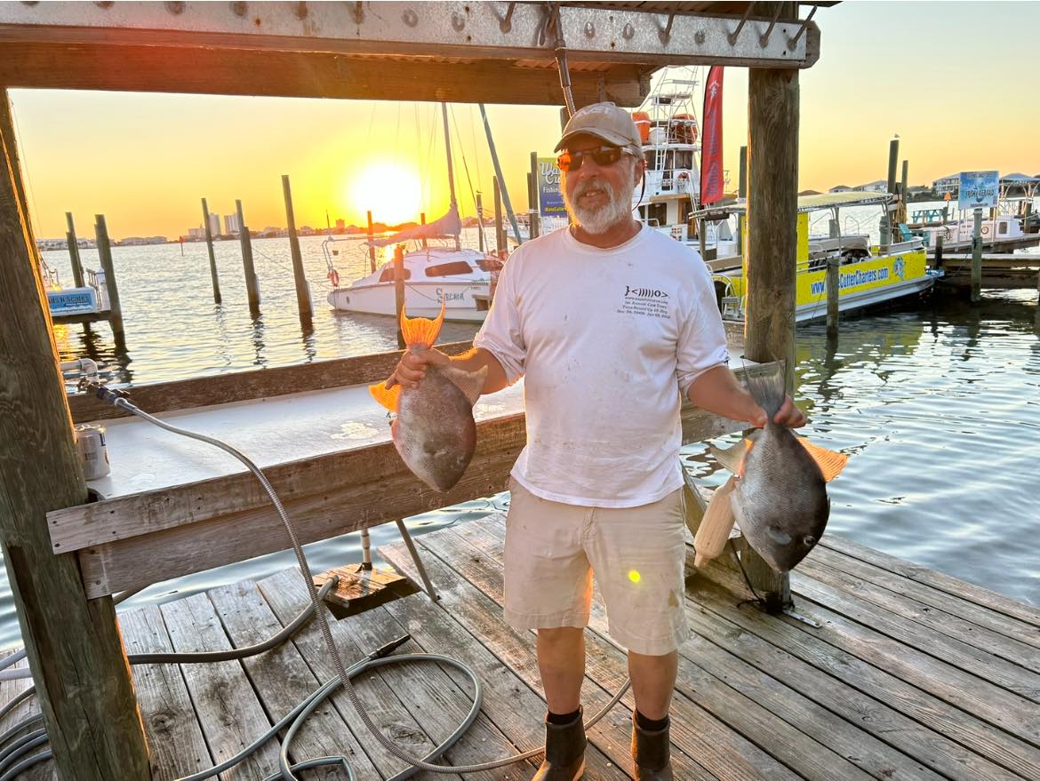 Grey triggerfish catch displayed on fishing dock at Pensacola Beach FL during sunset