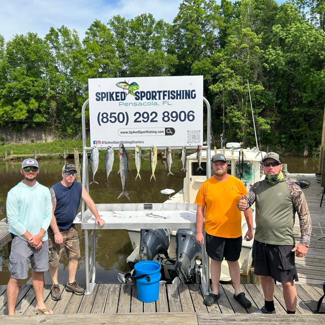 Successful fishing charter displaying fresh caught Mahi Mahi and King Mackerel on cleaning station at Pensacola Beach FL