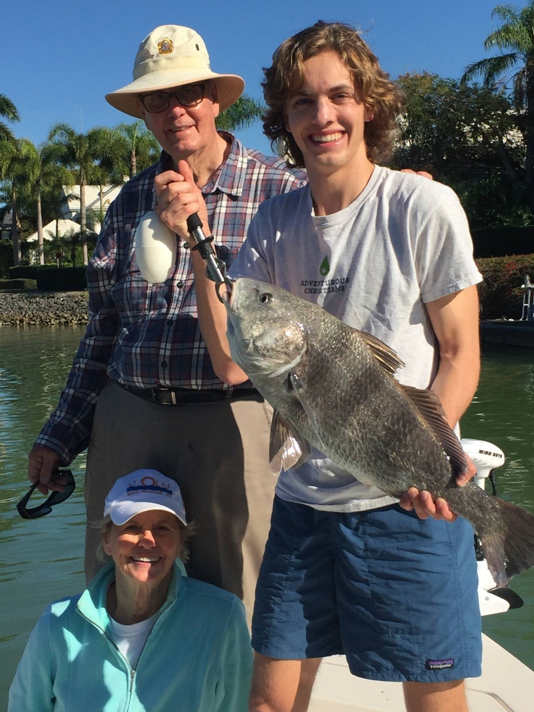 Angler holding a black drum fish in Florida