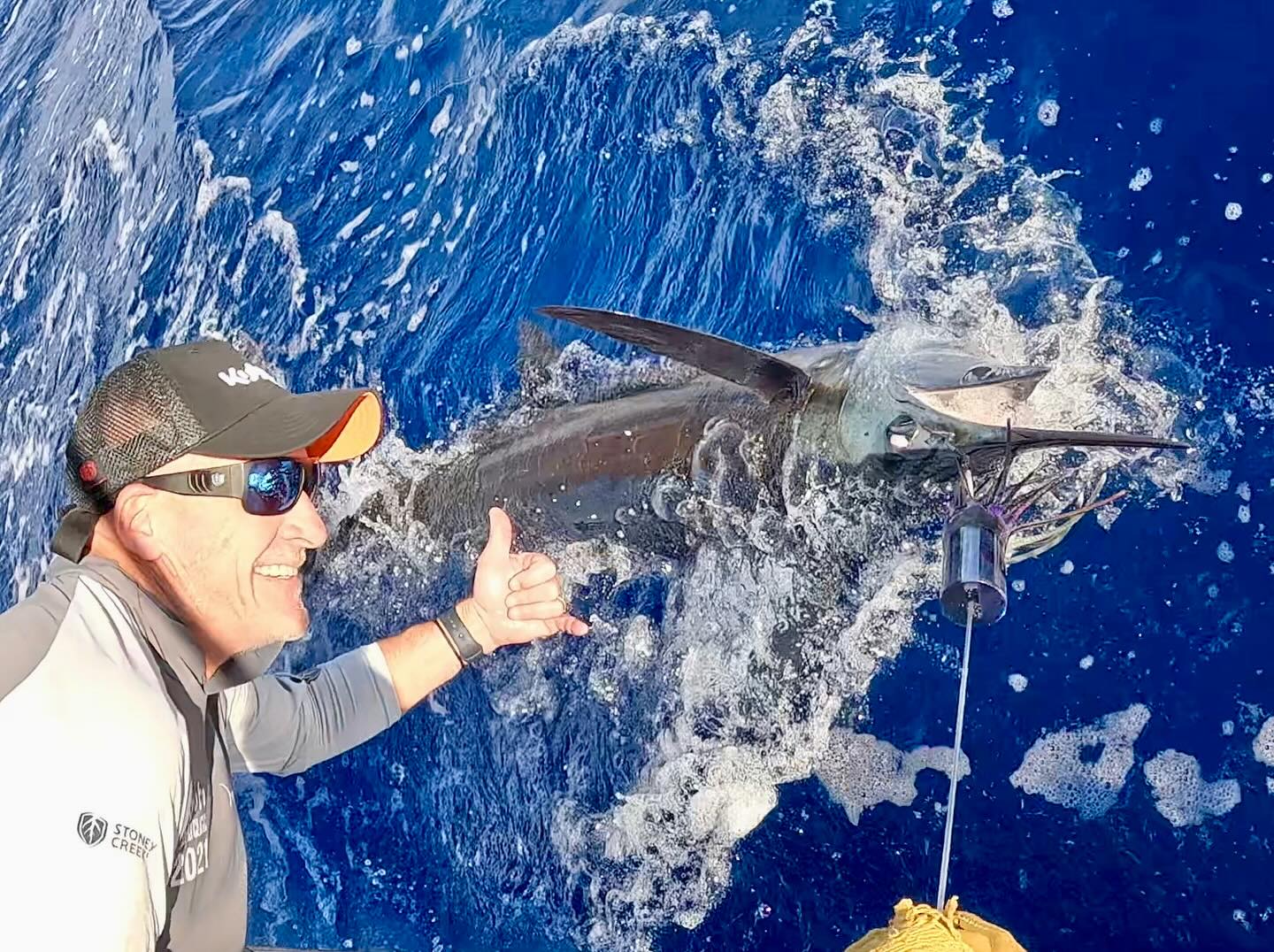 A lone fisherman in Kailua-Kona catching a 14-inch fish