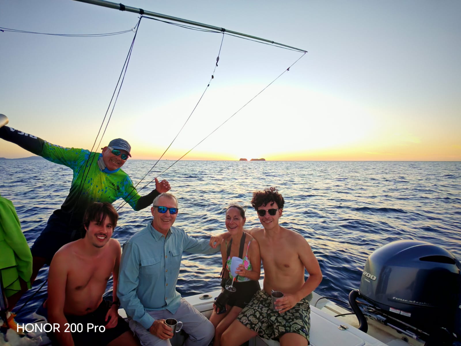 Fishing boat at sunset on ocean waters in Guanacaste with fishing equipment and rigging visible