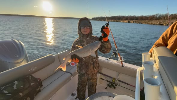 Fishing boat on lake in Sand Springs OK with caught fish and fishing equipment