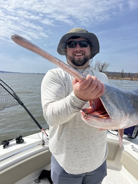 Angler holding large fish catch on boat in Sand Springs OK