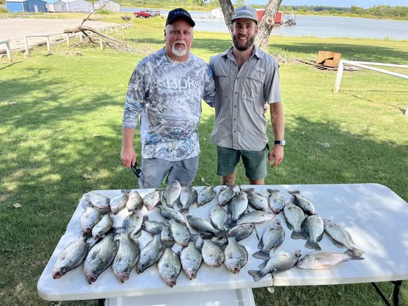 Large catch of fish displayed on table after successful fishing trip in Lewisville TX