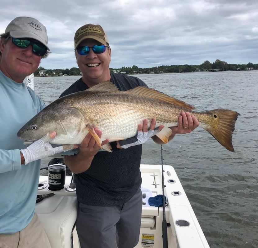 A person fishing in FL with a 30-inch fish