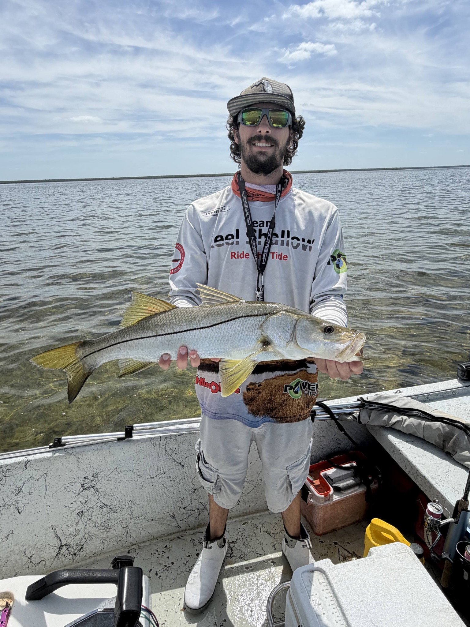 Angler holding a snook on fishing boat in Spring Hill FL waters