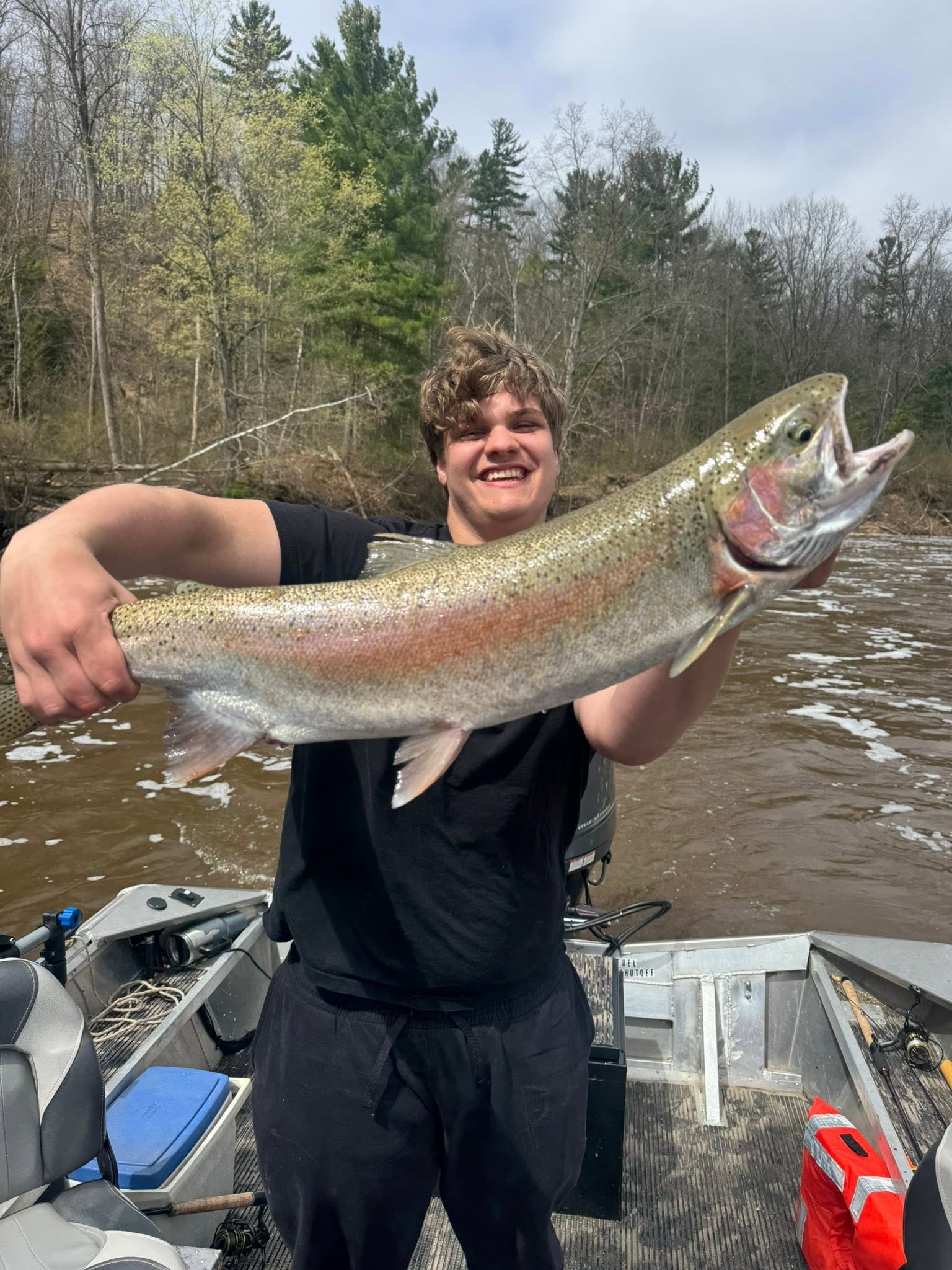 Large rainbow trout catch held on fishing boat in Brethren MI