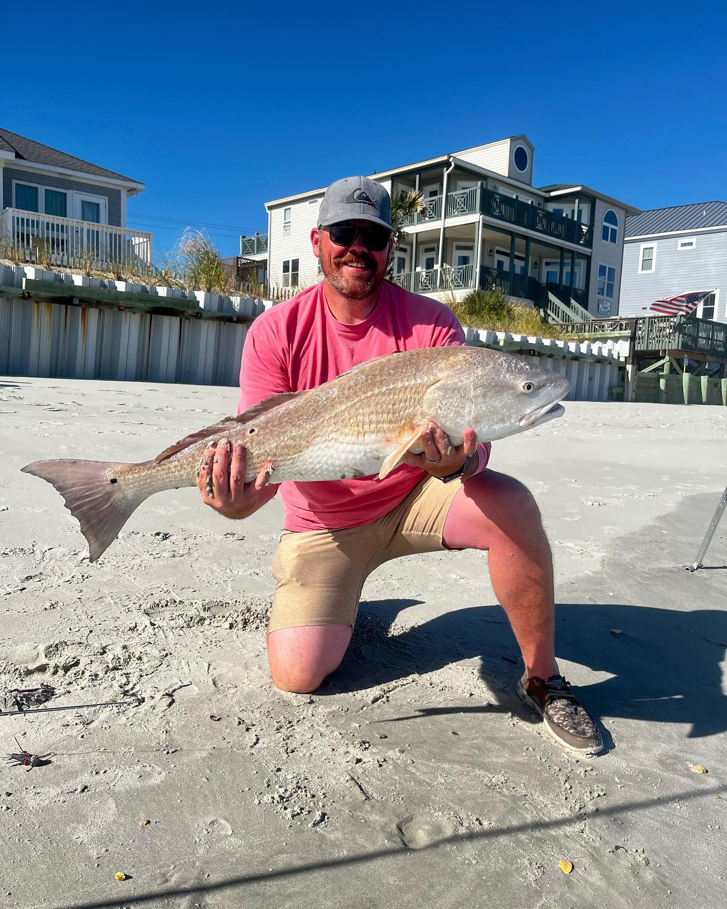 Angler holding a big redfish caught at Murrells Inlet