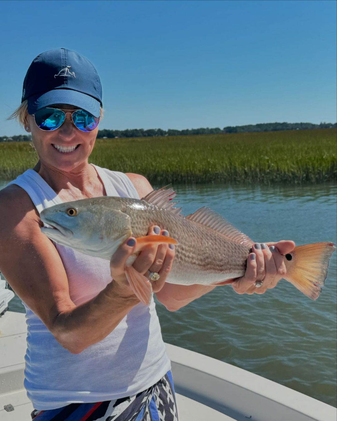 Angler with a 15-inch redfish caught at Folly Beach