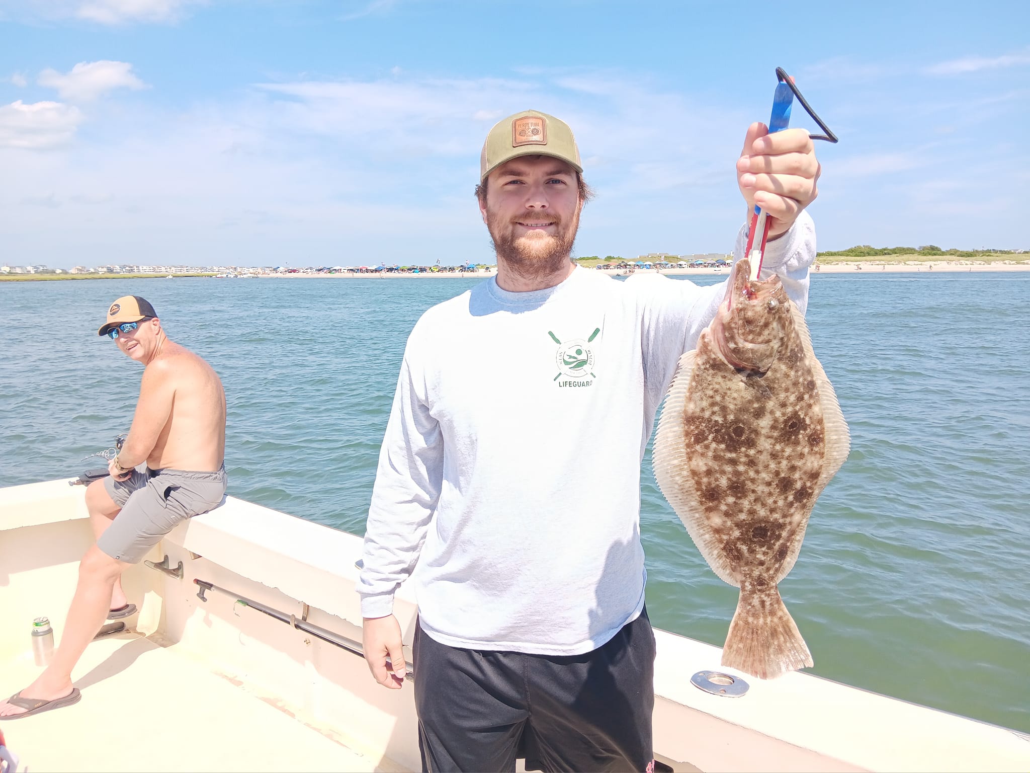 Fisherman holding a 40-inch European flounder in Brigantine
