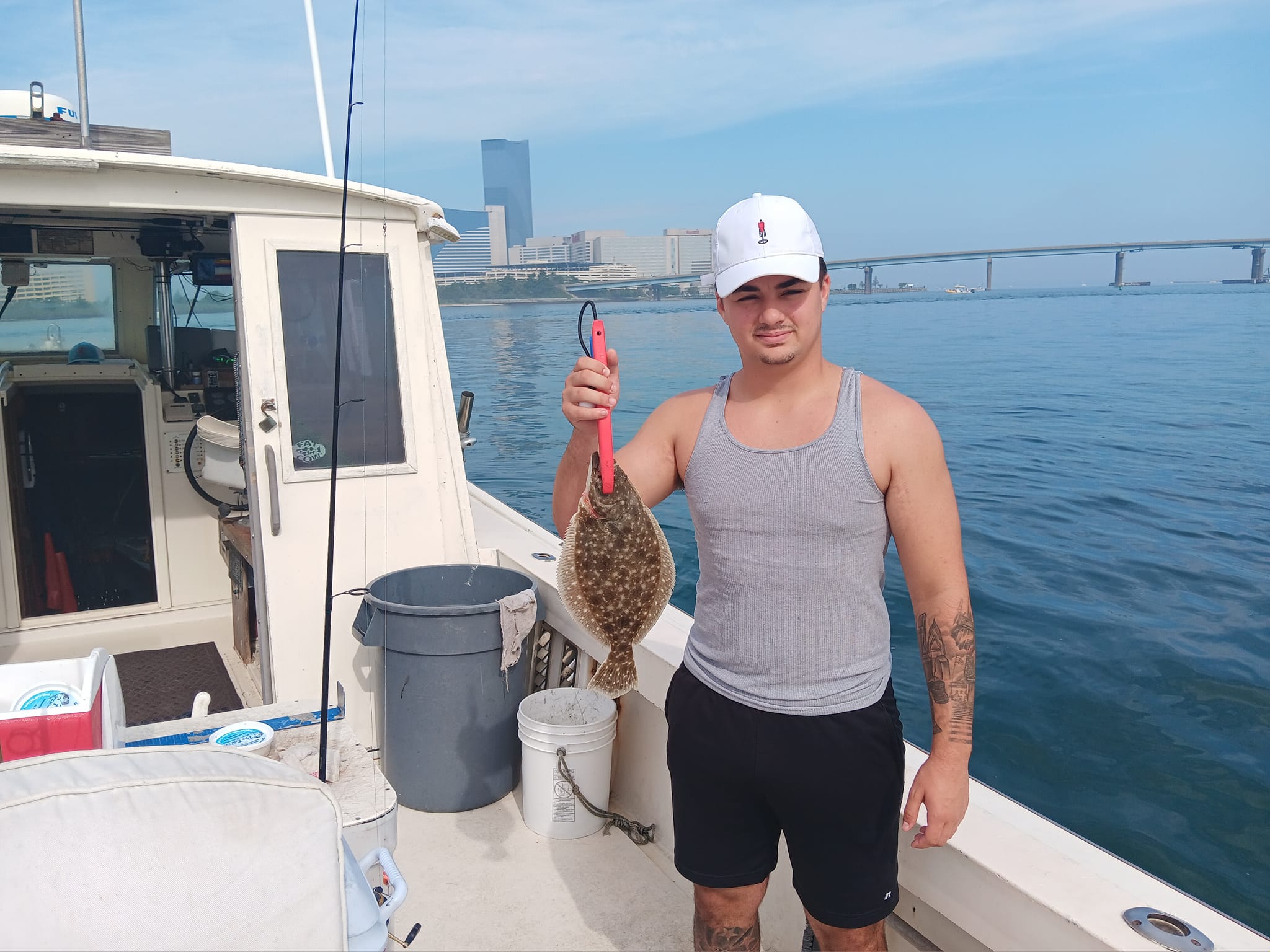 Angler holding a southern flounder fish catch in Brigantine