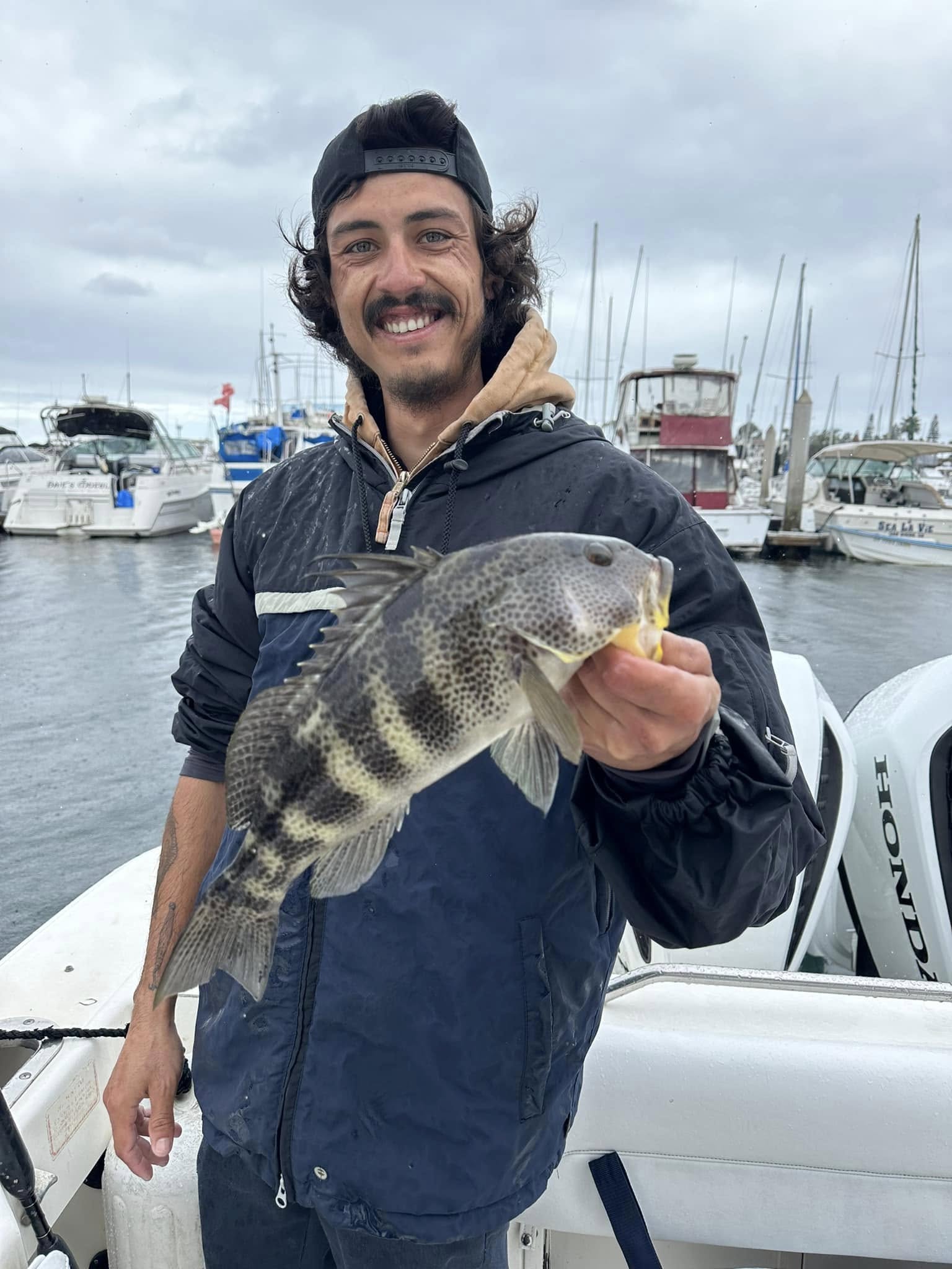 Photograph of a person fishing for a Black Drum in San Diego