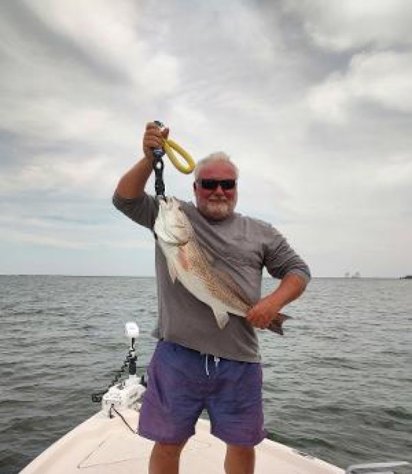 Angler reeling in 14-inch fish in FL