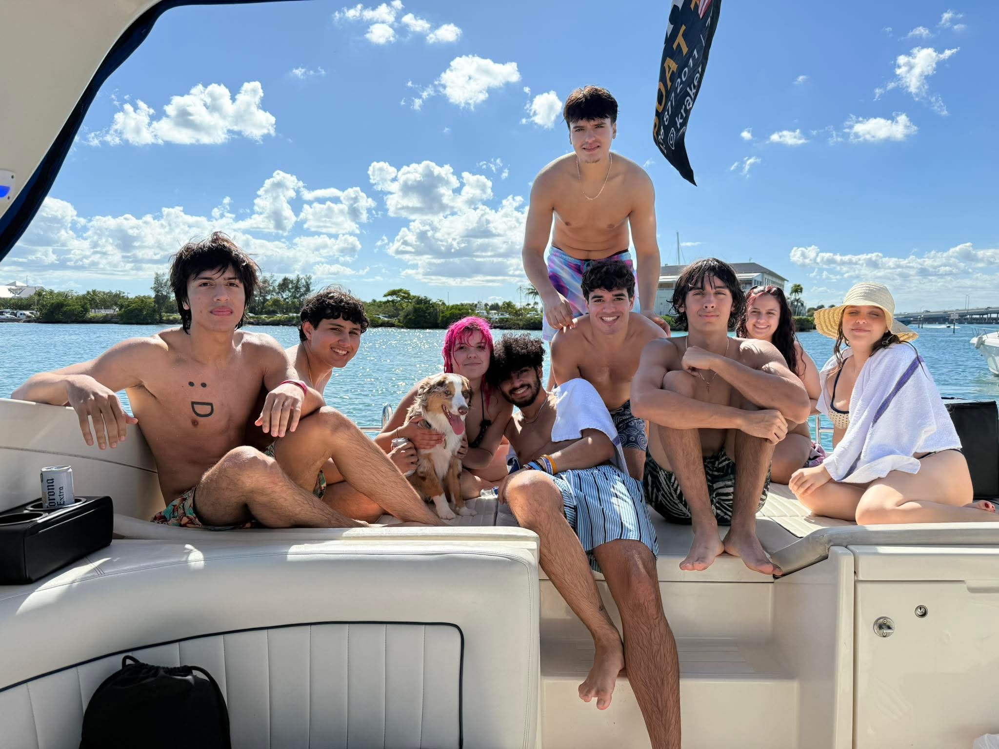 Group enjoying cruise boat outing in Miami FL waters with clear blue sky