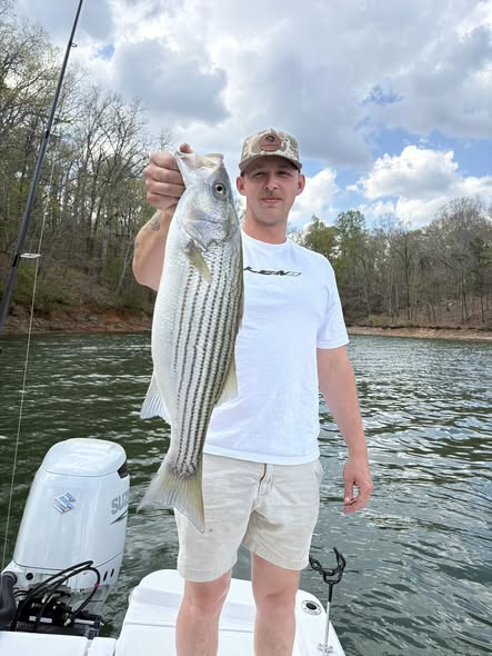 Beginner bass fishing guide boat on Lake Lanier Georgia with fishing rods and equipment ready