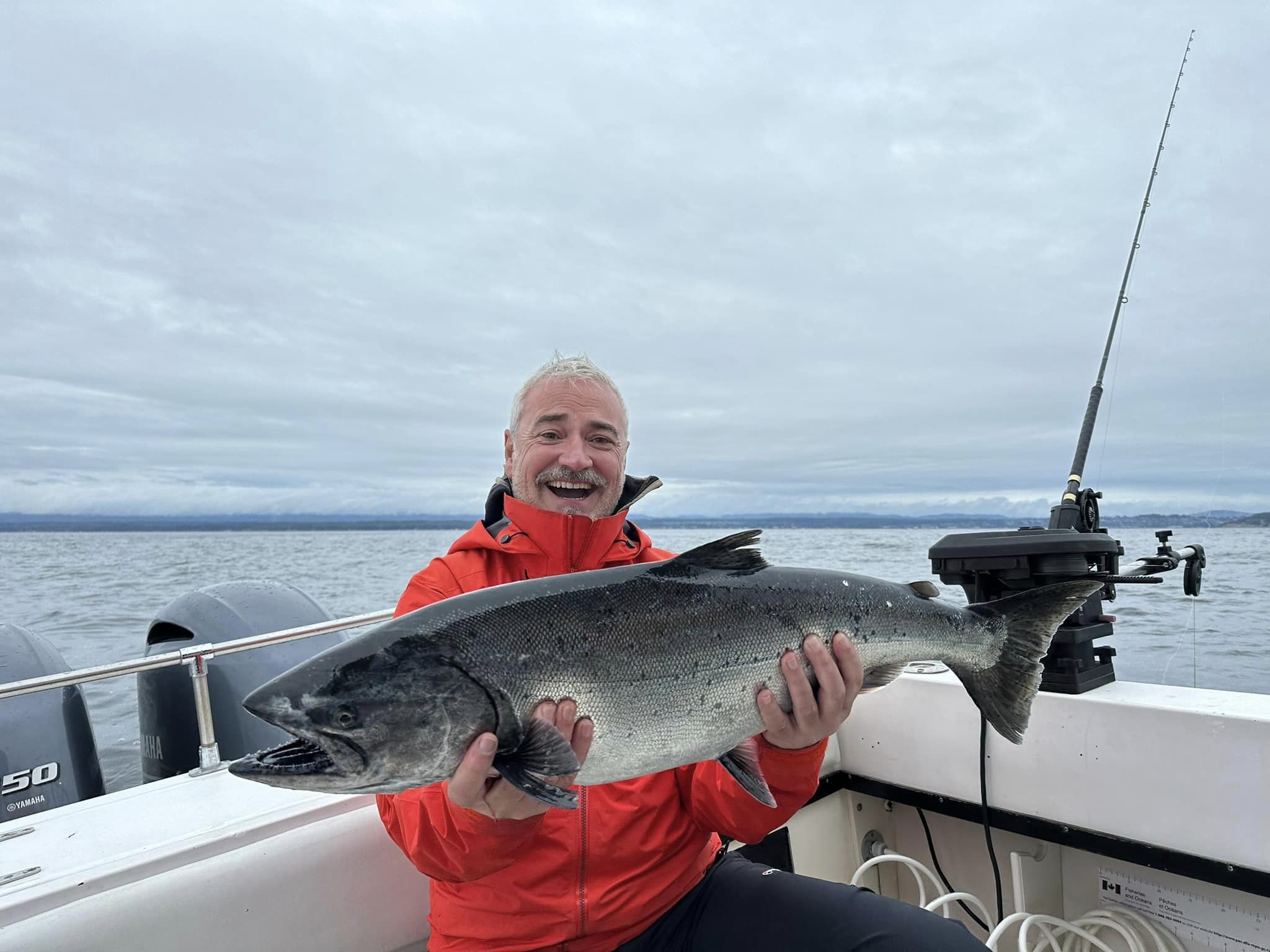 A lone fisherman reels in a big catch in the scenic town of Campbell River