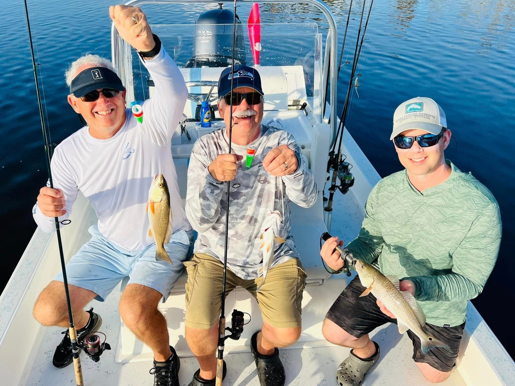 Three people fishing at the Placida location