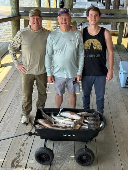 Fresh caught fish displayed in black wagon on wooden dock in Golden Meadow LA