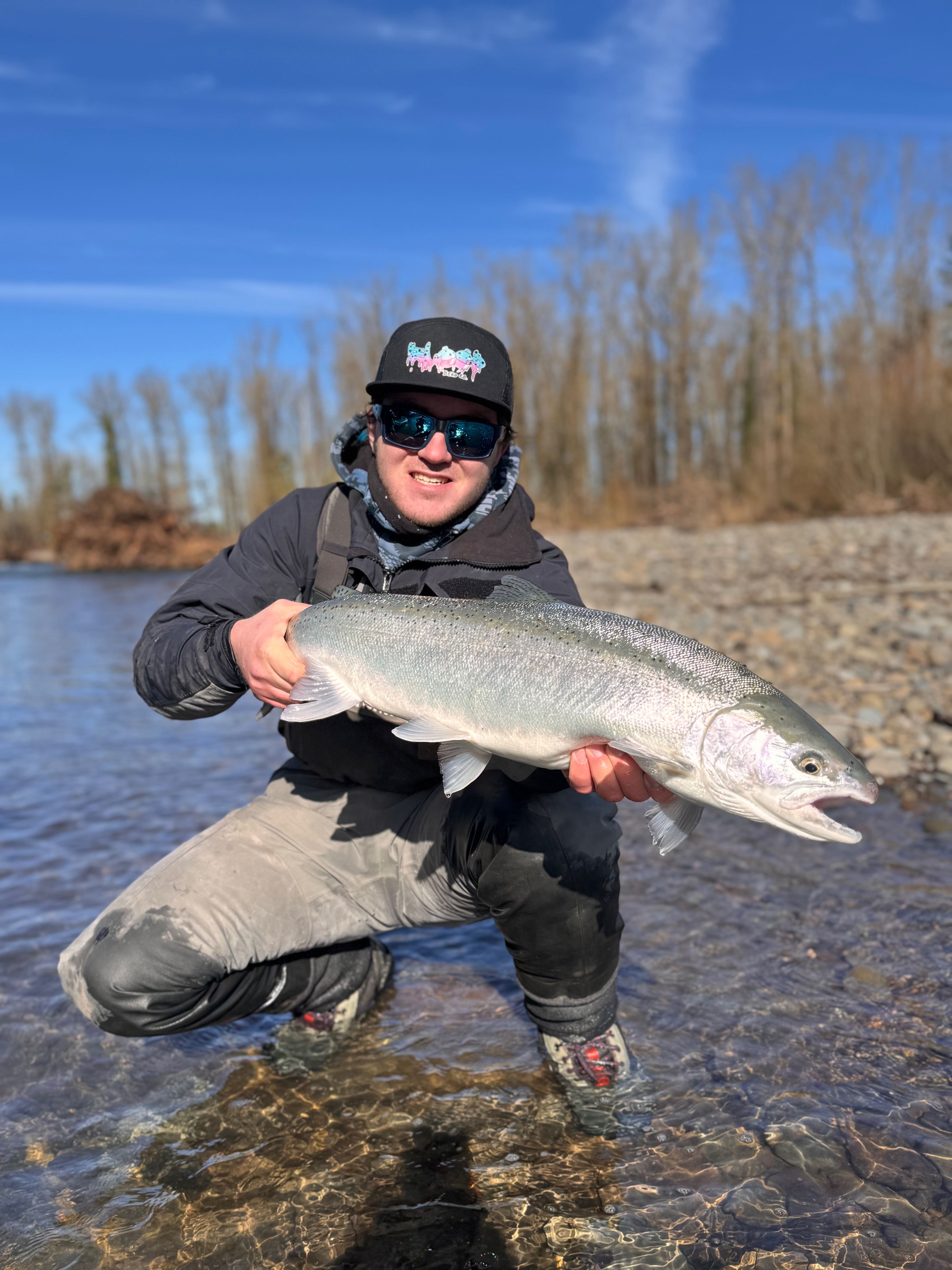 Large steelhead fish being held at river in Portland OR